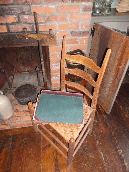 Dutch oven, primitive candlestand, ladder-back side chair