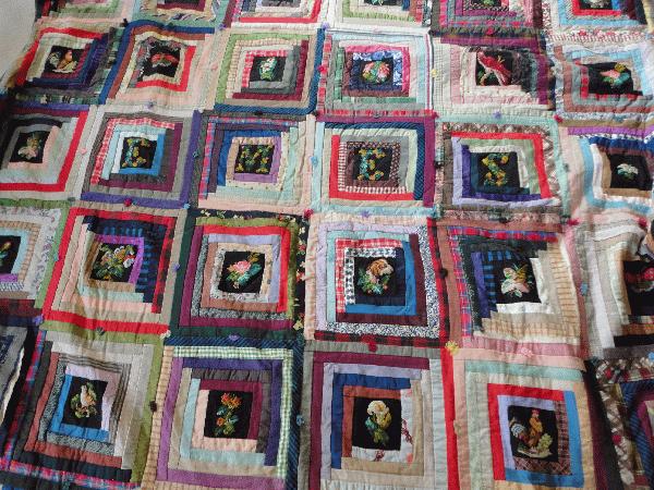 wonderful log cabin quilt with needlepoint inserts