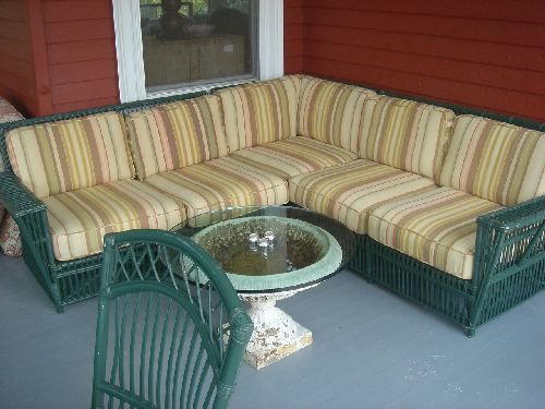 Maine Cottage sectional sofa and early cast iron urn with glass top